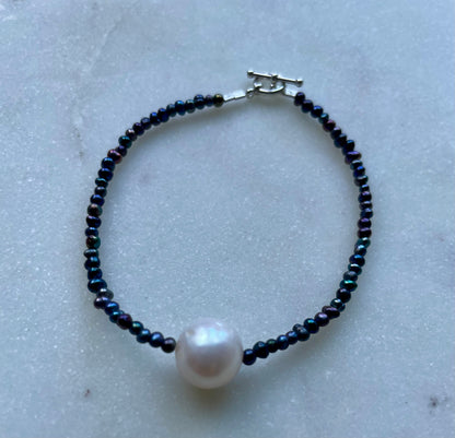 Solo pearl on peacock pearls