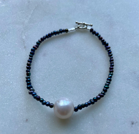 Solo pearl on peacock pearls