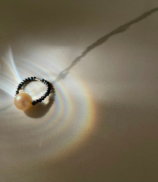 The Ocean Halo ring on peacock pearls